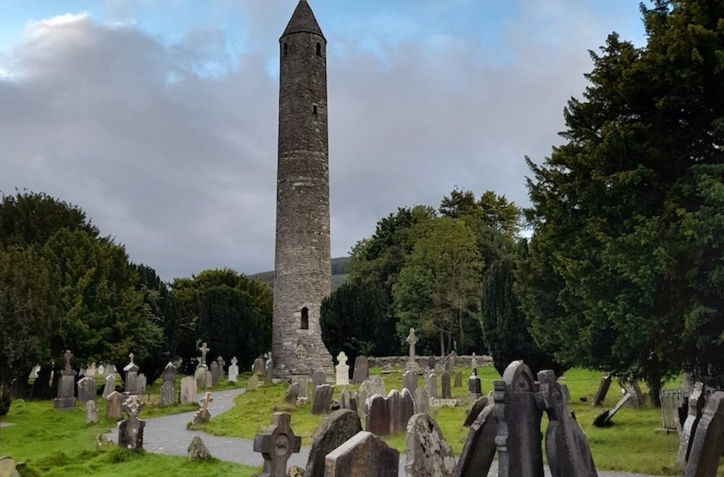 Glendalough round tower with graveyard in forground